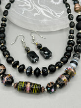 Load image into Gallery viewer, Elegantly crafted from black rectangular and circular glass beads, these dainty earrings offer a versatile style that can effortlessly elevate any ensemble.  Measurements: 1 3/8” in length
