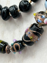 Load image into Gallery viewer, Add flair to your look with this unique large and chunky hand beaded necklace. Featuring a wide variety of mixed black glass beads in different sizes and shapes, this intricately-crafted statement piece offers a bold, hippie-chic, shabby-chic, and bohemian style.  Measurements:  Necklace is 18” in length, can be adjusted up to 20&quot;
