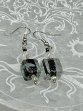 Load image into Gallery viewer, This striking set of earrings features large square-shaped clear glass beads adorned with black-and-white designs. Neutral-hued stone beads lend a cool feel, making them both unique and versatile. Measurements: 1 1/4” in length
