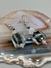 Load image into Gallery viewer, This striking set of earrings features large square-shaped clear glass beads adorned with black-and-white designs. Neutral-hued stone beads lend a cool feel, making them both unique and versatile. Measurements: 1 1/4” in length
