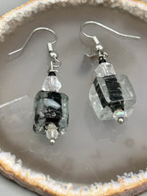 Load image into Gallery viewer, This striking set of earrings features large square-shaped clear glass beads adorned with black-and-white designs. Neutral-hued stone beads lend a cool feel, making them both unique and versatile.  Measurements: 1 1/4” in length
