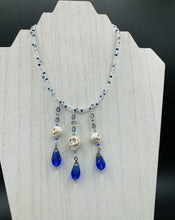 Load image into Gallery viewer, This adjustable collar-style necklace features two shimmery strands of silver and blue glass beads, with three skull charms boasting large, luminous blue teardrop glass beads adding extra shimmer and movement.  Measurements:  Necklace is 14 3/8” adjustable up to 18" in length
