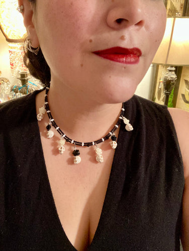 This sophisticated, yet dark-themed necklace utilizes small howlite skull beads along with black and white quartize floral beads to capture the iconic floral crown of Frida Kahlo. This Chingona, Cabrona, Latina Chicana, Goth, Vampire Goth, Dark Witchy Style jewelry can be used to inspire and to celebrate Dia de los Muertos. Equally suitable for dressy and casual outfits, the piece gives a unique edge to any look.