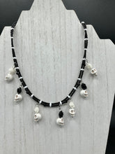 Load image into Gallery viewer, This sophisticated, yet dark-themed necklace utilizes small howlite skull beads along with black and white quartize floral beads to capture the iconic floral crown of Frida Kahlo. This Chingona, Cabrona, Latina Chicana, Goth, Vampire Goth, Dark Witchy Style jewelry can be used to inspire and to celebrate Dia de los Muertos. Equally suitable for dressy and casual outfits, the piece gives a unique edge to any look.
