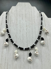 Load image into Gallery viewer, This sophisticated, yet dark-themed necklace utilizes small howlite skull beads along with black and white quartize floral beads to capture the iconic floral crown of Frida Kahlo. This Chingona, Cabrona, Latina Chicana, Goth, Vampire Goth, Dark Witchy Style jewelry can be used to inspire and to celebrate Dia de los Muertos. Equally suitable for dressy and casual outfits, the piece gives a unique edge to any look.
