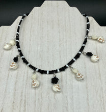 Load image into Gallery viewer, This sophisticated, yet dark-themed necklace utilizes small howlite skull beads along with black and white quartize floral beads to capture the iconic floral crown of Frida Kahlo. This Chingona, Cabrona, Latina Chicana, Goth, Vampire Goth, Dark Witchy Style jewelry can be used to inspire and to celebrate Dia de los Muertos. Equally suitable for dressy and casual outfits, the piece gives a unique edge to any look.
