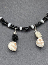 Load image into Gallery viewer, This sophisticated, yet dark-themed necklace utilizes small howlite skull beads along with black and white quartize floral beads to capture the iconic floral crown of Frida Kahlo. This Chingona, Cabrona, Latina Chicana, Goth, Vampire Goth, Dark Witchy Style jewelry can be used to inspire and to celebrate Dia de los Muertos. Equally suitable for dressy and casual outfits, the piece gives a unique edge to any look.
