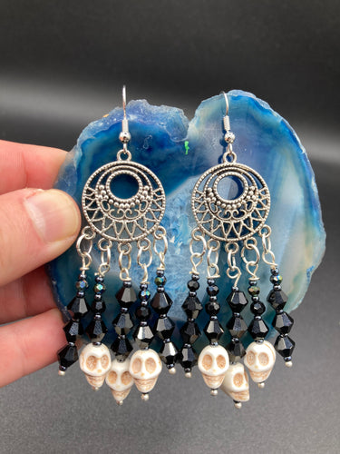 These Gothic Skulls Black Glass Beaded Earrings are a chic fashion statement that can enhance any look. Show off your inner Chingona, Cabrona, Latina Chicana, Goth, Vampire Goth, Dark Witchy, La Bruja Style with a cascade of shimmery skulls. Both formal and informal occasions can be elevated with these stylish earrings.  Measurements: 2 3/4 ” in length