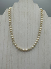 Load image into Gallery viewer, This single strand necklace features gold tone faux pearl beads for a classic, elegant aesthetic. Measurements:   Necklace is 18&quot; in length
