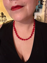 Load image into Gallery viewer, This ruby red heart-shaped glass beaded necklace features a shimmery, translucent finish and a lobster claw clasp.  Measurements:    Necklace is 18 1/2&quot; in length
