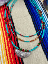 Load image into Gallery viewer, Three strands of Southwestern Style Inspired Adjustable Choker Beaded Necklace features an eye-catching blend of vibrant turquoise, red, green, gold, and yellow glass beads, accented with a wide silver plated tribal pattern pendant.  Measurements:  Necklace is 15 1/2” adjustable up to 18" in length
