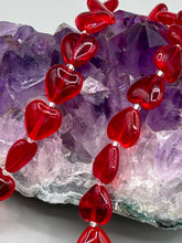 Load image into Gallery viewer, This ruby red heart-shaped glass beaded necklace features a shimmery, translucent finish and a lobster claw clasp.  Measurements:    Necklace is 18 1/2&quot; in length
