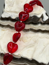 Load image into Gallery viewer, This ruby red heart-shaped glass beaded necklace features a shimmery, translucent finish and a lobster claw clasp.  Measurements:    Necklace is 18 1/2&quot; in length
