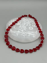 Load image into Gallery viewer, This ruby red heart-shaped glass beaded necklace features a shimmery, translucent finish and a lobster claw clasp.  Measurements:    Necklace is 18 1/2&quot; in length
