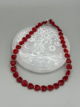Load image into Gallery viewer, This ruby red heart-shaped glass beaded necklace features a shimmery, translucent finish and a lobster claw clasp.  Measurements:    Necklace is 18 1/2&quot; in length
