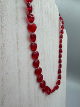 Load image into Gallery viewer, This ruby red heart-shaped glass beaded necklace features a shimmery, translucent finish and a lobster claw clasp.  Measurements:    Necklace is 18 1/2&quot; in length
