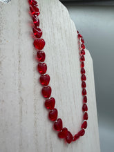 Load image into Gallery viewer, This ruby red heart-shaped glass beaded necklace features a shimmery, translucent finish and a lobster claw clasp.  Measurements:    Necklace is 18 1/2&quot; in length
