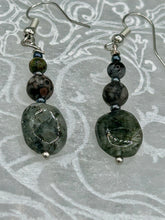 Load image into Gallery viewer, These tourmaline quartz and snowflake obsidian beaded earrings have a cool, neutral tone that's perfect for hippie and boho chic looks. The silver glass beads add a sparkle to any outfit and are ideal for anyone seeking a unique, nature-inspired style.  Measurements: 1 1/2” in length
