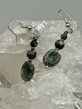Load image into Gallery viewer, These tourmaline quartz and snowflake obsidian beaded earrings have a cool, neutral tone that's perfect for hippie and boho chic looks. The silver glass beads add a sparkle to any outfit and are ideal for anyone seeking a unique, nature-inspired style.  Measurements: 1 1/2” in length
