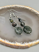 Load image into Gallery viewer, These tourmaline quartz and snowflake obsidian beaded earrings have a cool, neutral tone that's perfect for hippie and boho chic looks. The silver glass beads add a sparkle to any outfit and are ideal for anyone seeking a unique, nature-inspired style.  Measurements: 1 1/2” in length
