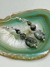 Load image into Gallery viewer, These tourmaline quartz and snowflake obsidian beaded earrings have a cool, neutral tone that's perfect for hippie and boho chic looks. The silver glass beads add a sparkle to any outfit and are ideal for anyone seeking a unique, nature-inspired style.  Measurements: 1 1/2” in length

