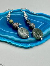 Load image into Gallery viewer, These tourmaline quartz and snowflake obsidian beaded earrings have a cool, neutral tone that's perfect for hippie and boho chic looks. The silver glass beads add a sparkle to any outfit and are ideal for anyone seeking a unique, nature-inspired style.  Measurements: 1 1/2” in length
