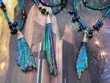 Load image into Gallery viewer, This celestial and galaxy goddess necklace features two strands of glass beading and a captivating Kyanite wired stone pendant. Its mixture of shimmering purples, blues, greens, and golds is truly striking and provides an alluring look like no other. Add this bold and beautiful jewelry piece to your collection today for a statement look that truly stands out. Necklace is 15” in length, can be adjusted to 18&quot;
