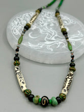 Load image into Gallery viewer, This exquisite necklace features natural ruby zoisite, snowflake obsidian, turquoise magnesite, bone, glass and metal beads, offering a variety of sizes, shapes, textures, and colors.
