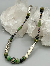 Load image into Gallery viewer, This exquisite necklace features natural ruby zoisite, snowflake obsidian, turquoise magnesite, bone, glass and metal beads, offering a variety of sizes, shapes, textures, and colors.
