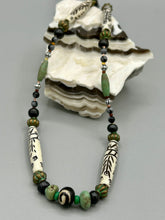 Load image into Gallery viewer, This exquisite necklace features natural ruby zoisite, snowflake obsidian, turquoise magnesite, bone, glass and metal beads, offering a variety of sizes, shapes, textures, and colors.
