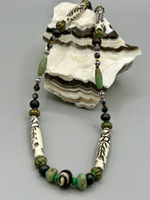Load image into Gallery viewer, This exquisite necklace features natural ruby zoisite, snowflake obsidian, turquoise magnesite, bone, glass and metal beads, offering a variety of sizes, shapes, textures, and colors.
