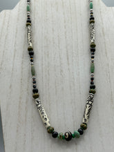 Load image into Gallery viewer, This exquisite necklace features natural ruby zoisite, snowflake obsidian, turquoise magnesite, bone, glass and metal beads, offering a variety of sizes, shapes, textures, and colors.
