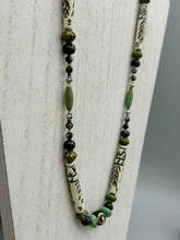 Load image into Gallery viewer, This exquisite necklace features natural ruby zoisite, snowflake obsidian, turquoise magnesite, bone, glass and metal beads, offering a variety of sizes, shapes, textures, and colors.
