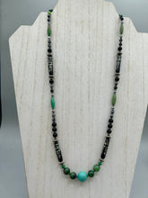 Load image into Gallery viewer, This necklace boasts a diverse selection of natural bead materials, including ruby zoisite, black and snowflake obsidian stones, plus turquoise magnesite, bone, glass and metal beads. This variety of sizes, shapes, textures and colors will make this necklace stand out.    Measurements:  Necklace - 23&quot; in length
