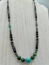 Load image into Gallery viewer, This necklace boasts a diverse selection of natural bead materials, including ruby zoisite, black and snowflake obsidian stones, plus turquoise magnesite, bone, glass and metal beads. This variety of sizes, shapes, textures and colors will make this necklace stand out.    Measurements:  Necklace - 23&quot; in length
