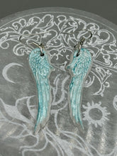 Load image into Gallery viewer, Light baby blue wings earrings made of polymer clay.  These earrings are designed to face forward when worn instead of the front wings showing on the side.
