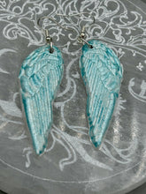 Load image into Gallery viewer, Light baby blue wings earrings made of polymer clay.  These earrings are designed to face forward when worn instead of the front wings showing on the side.

