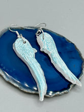 Load image into Gallery viewer, Light baby blue wings earrings made of polymer clay.  These earrings are designed to face forward when worn instead of the front wings showing on the side.
