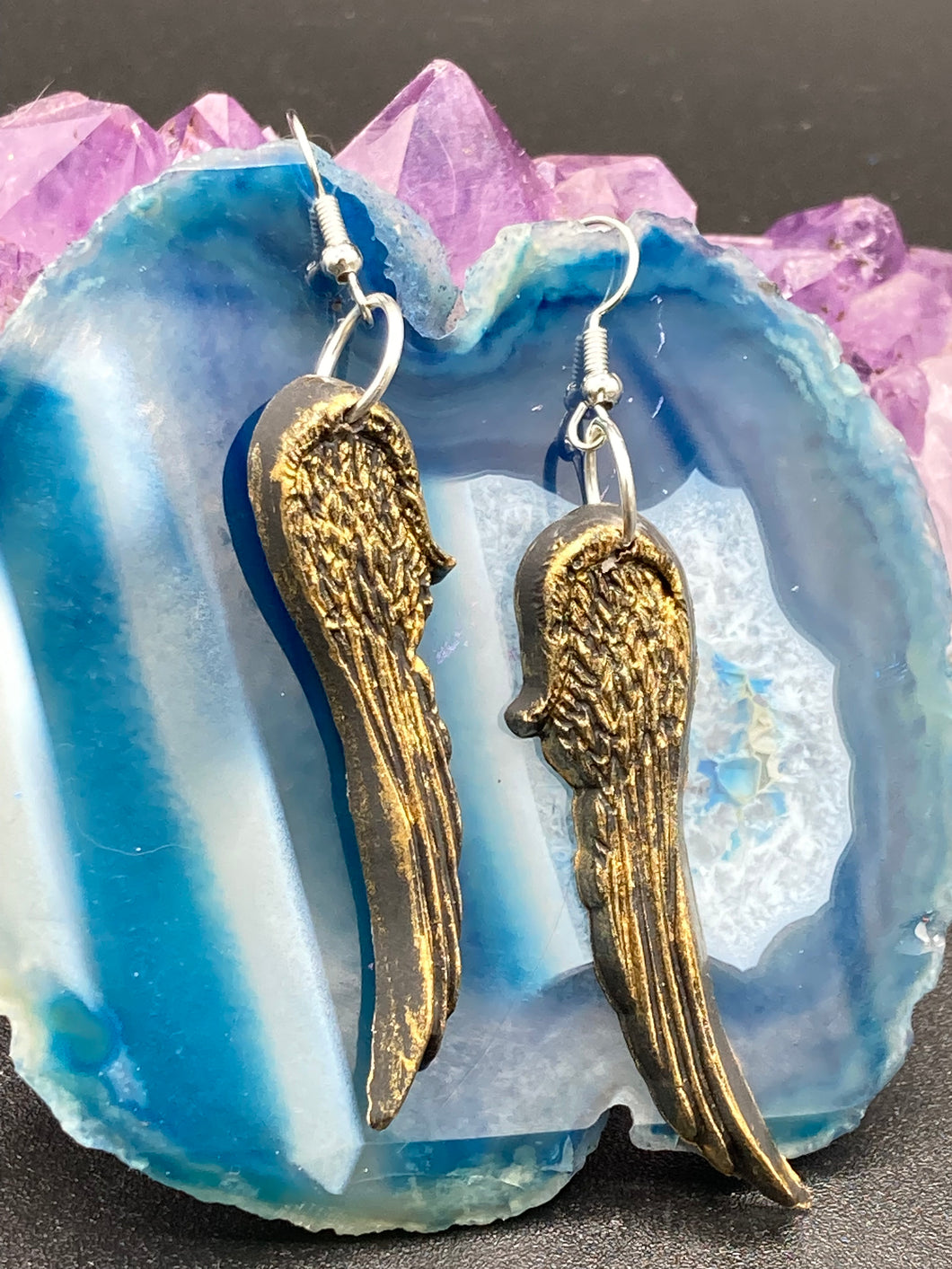 Sparkling gold tone angel wings earrings made of polymer clay.  These earrings are designed to face forward when worn instead of the front wings showing on the side.