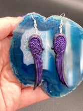 Load image into Gallery viewer, Sparkling dark purple angel wings earrings made of polymer clay.  These earrings are designed to face forward when worn instead of the front wings showing on the side.
