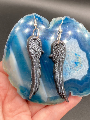 Chrome-colored silver angel wings earrings crafted with polymer clay. Featuring a construction designed to ensure the front wings face forward when worn.