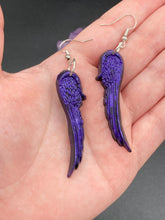 Load image into Gallery viewer, Sparkling dark purple angel wings earrings made of polymer clay.  These earrings are designed to face forward when worn instead of the front wings showing on the side.
