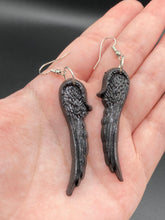 Load image into Gallery viewer, Shimmery black angel wings earrings made of polymer clay.  These earrings are designed to face forward when worn instead of the front wings showing on the side.
