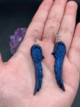 Load image into Gallery viewer, These eye-catching electric blue angel wings earrings are expertly crafted from polymer clay. Featuring an innovative design, they ensure the wings face forward when worn.
