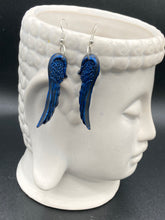 Load image into Gallery viewer, These eye-catching electric blue angel wings earrings are expertly crafted from polymer clay. Featuring an innovative design, they ensure the wings face forward when worn.
