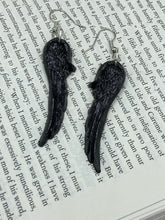 Load image into Gallery viewer, Shimmery black angel wings earrings made of polymer clay.  These earrings are designed to face forward when worn instead of the front wings showing on the side.
