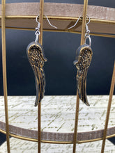 Load image into Gallery viewer, Sparkling gold tone angel wings earrings made of polymer clay.  These earrings are designed to face forward when worn instead of the front wings showing on the side.
