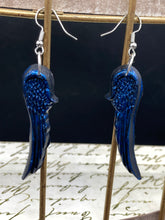 Load image into Gallery viewer, These eye-catching electric blue angel wings earrings are expertly crafted from polymer clay. Featuring an innovative design, they ensure the wings face forward when worn.

