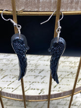 Load image into Gallery viewer, Shimmery black angel wings earrings made of polymer clay.  These earrings are designed to face forward when worn instead of the front wings showing on the side.
