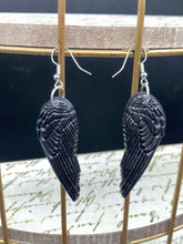 Load image into Gallery viewer, Shimmery black angel wings earrings made of polymer clay.  These earrings are designed to face forward when worn instead of the front wings showing on the side.
